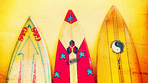 The logos identify these three boards as vintage shortboards